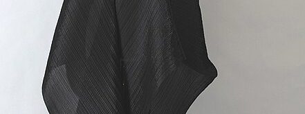 Black pleated polyester ensemble by Issey Miyake, 2004.jpg