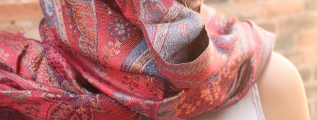  A woman wearing a scarf made from a pattern / The silk scarf - red.